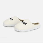 Custom-made white plush home slippers: cute eyelash embroidery, tailored sizing for warm, playful indoor wear.