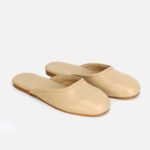 Premium beige leather mule slippers for women, lightweight slip-on closed-toe shoes with smooth finish.