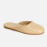 Minimalist beige leather mule slippers for women, comfortable flat slip-on shoes for casual or office wear.