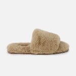 A personalized one-strap slide slipper in warm beige, constructed with genuine sheepskin and tailored for individual fit.
