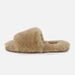 A personalized one-strap slipper in soft beige, crafted from premium sheepskin with custom sizing and design options.
