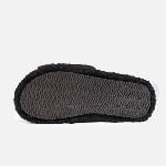 A single tailored black slide slipper crafted from premium faux shearling fur, featuring a subtle custom label detail on the upper.