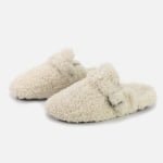 Custom cream fuzzy home slippers with sheepskin fur and buckle detail—custom-fit for cozy indoor comfort.