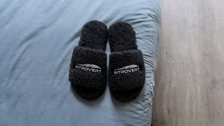 Luxury black faux shearling fur open-toe slippers with custom embroidered logo and wave design. Soft plush loungewear footwear for home use, ideal for private label and branding.